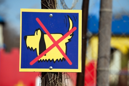 "No Dogs" sign with funny little dog and red cross over itの写真素材