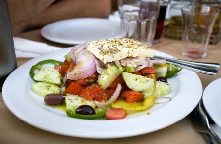 Greek salad from fresh vegetables on white plate closeupの写真素材