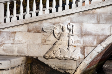 woman with anchor bas-relief of Rialto bridge in Venice, closeup front viewのeditorial素材