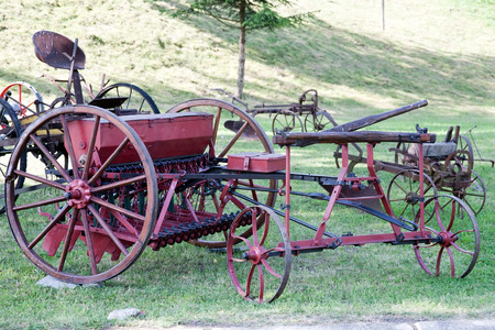 old farm agriculture equipment closeup on green grass backgroundのeditorial素材