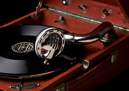 gramophone with old vinyl record and metal pickup closeup view