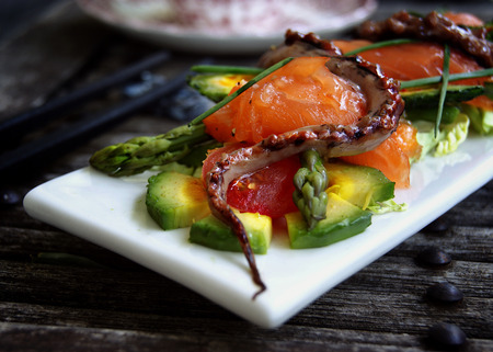 Gentle salad with a salmon, a squid, an asparagus, avocado and mamadikaの写真素材