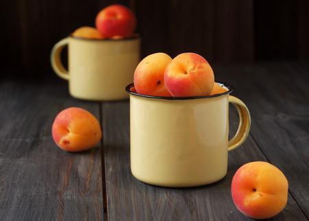 Juicy fresh peaches in a bucketの写真素材