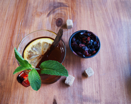 Flavored with mint tea and sweets on a wooden backgroundの写真素材