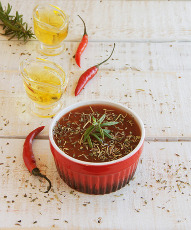 tomato sauce with chili and bottles on a wooden tableの写真素材