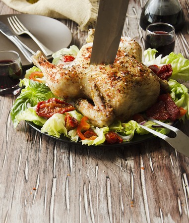 raw chicken with herbs spices ingredients, ready for cooking, on a wooden table, selective focusの写真素材