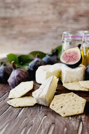 figs with cheese and honey on a wooden table selective focusの写真素材