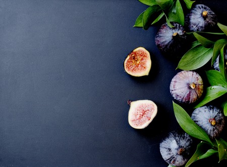 figs with leaves on a black background, space for text, selective focusの写真素材