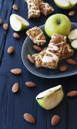 Cookies of cereals with appeles and berries on a wooden tableの写真素材