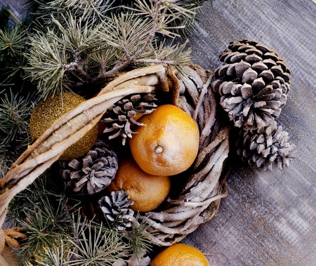 Christmas card with fir branches, tangerines, pine cones, and decoration elements , selective focusの写真素材