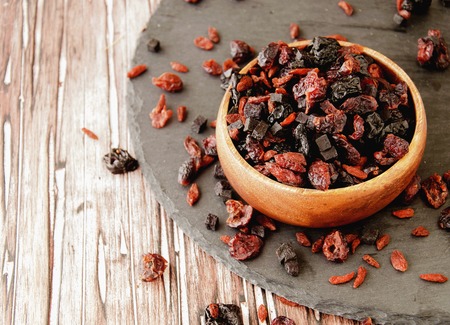 sliced dried fruits in a wooden bowl on the table in the Arab style, selective focus, space for textの写真素材