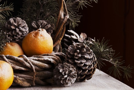 Christmas card decoration with fir branches, tangerines, pine cones, and decoration elements , selective focusの写真素材