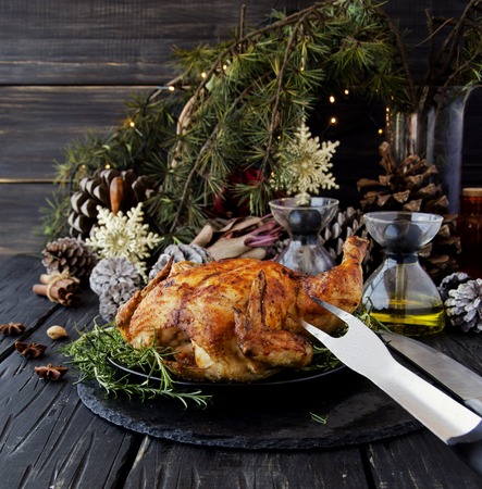 Roast chicken or turkey for Christmas and New Year with mulled wine and Christmas decorations, selective focusの写真素材