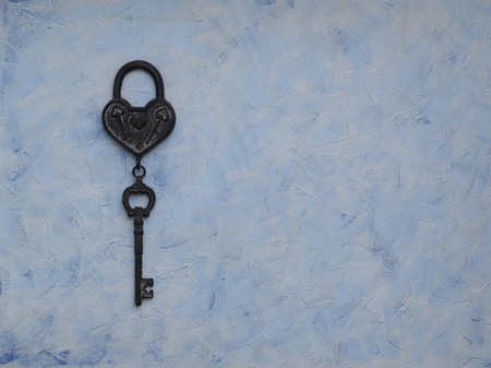 iron key from the lock lying on a wooden vintage background, top viewの写真素材