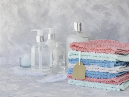 Towel stack with a price tag on a white marble background, space for text, selective focusの写真素材
