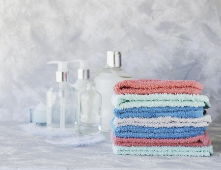 stack of towels for bathroom bottle on a white marble background, space for text, selective focusの写真素材