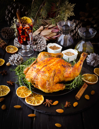 Roast chicken or turkey for Christmas and New Year with mulled wine and Christmas decorations, selective focusの写真素材