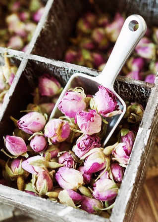 small dry buds of roses, tea, karkade, in wooden box, selective focusの写真素材