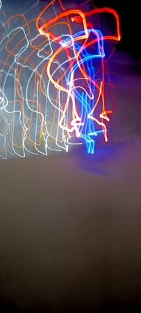 Abstract multicolored lines on a black background. Long exposure photo.の写真素材