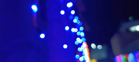 Black background with golden light effects. Horizontal background with blur bokeh effects for Christmas time. Color light overlayの写真素材