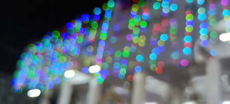 Black background with golden light effects. Horizontal background with blur bokeh effects for Christmas time. Color light overlayの写真素材