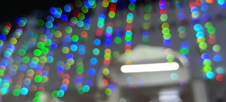 Black background with golden light effects. Horizontal background with blur bokeh effects for Christmas time. Color light overlayの写真素材