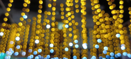 circular reflections of lights abstract blurred of red and gold glittering shine bulbs lights background. defocused golden lightsの写真素材