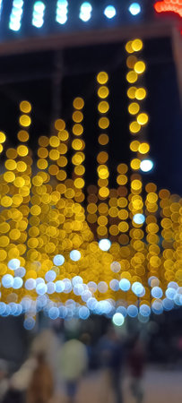 circular reflections of lights abstract blurred of red and gold glittering shine bulbs lights background. defocused golden lightsの写真素材