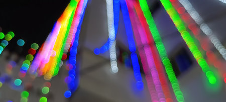 Black background with golden light effects. Horizontal background with blur bokeh effects for Christmas time. Color light overlayの写真素材