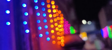 Black background with golden light effects. Horizontal background with blur bokeh effects for Christmas time. Color light overlayの写真素材