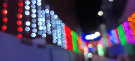 circular reflections of lights abstract blurred of red and gold glittering shine bulbs lights background. defocused golden lightsの写真素材