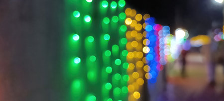 Black background with golden light effects. Horizontal background with blur bokeh effects for Christmas time. Color light overlayの写真素材