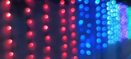 Black background with golden light effects. Horizontal background with blur bokeh effects for Christmas time. Color light overlayの写真素材