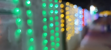 Black background with golden light effects. Horizontal background with blur bokeh effects for Christmas time. Color light overlayの写真素材