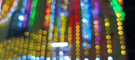 Black background with golden light effects. Horizontal background with blur bokeh effects for Christmas time. Color light overlayの写真素材