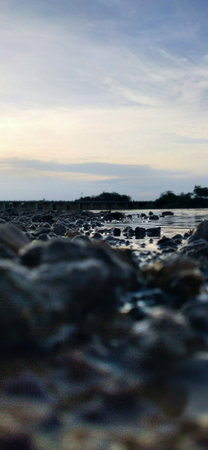 Background of colorful beach pebbles of different shapes and water. Colorful Stones On A Mountain...