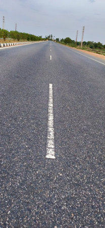 Asphalt road with white line on the side. Abstract background.