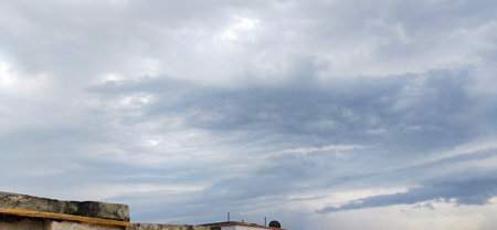 Clouds in the sky over the roofs of the old city.の写真素材