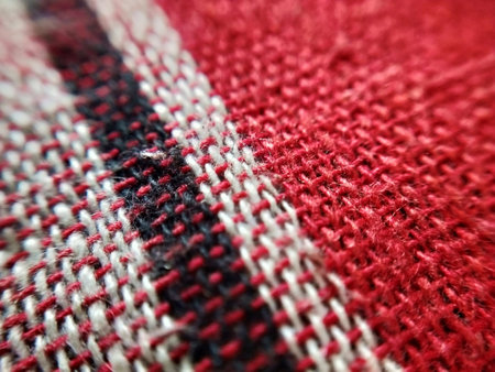 macro of a red and white woolen fabric with a patternの写真素材