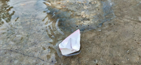 Paper boat floating on the water.の写真素材