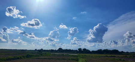 Panoramic view of the sky with clouds and sun in summer