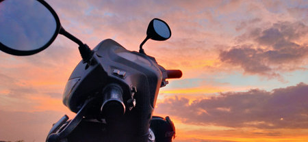motorcycle with glasses on a background of the sunset sky.