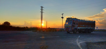 Truck on the road at sunset. Transport in the city.の写真素材