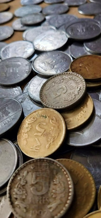 Coins of different countries are scattered on the table close-upの写真素材