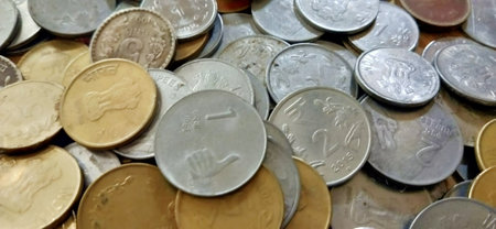 Close-up of coins from different countries. The concept of saving money.