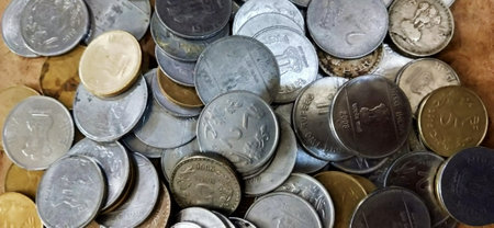 Coins of different countries are scattered on the table. Background for business