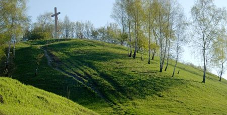 Cross on green spring hill (panorama, two shots)の写真素材