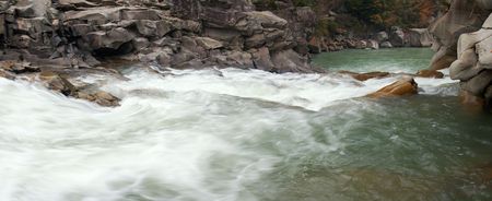 Autumn mountain river view with waterfall