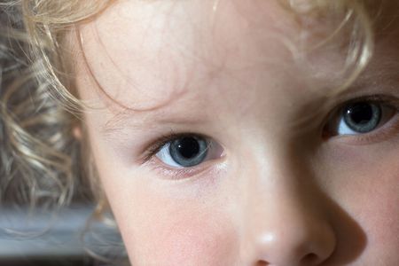 Small girl facial close - up portrait (indoor)の写真素材