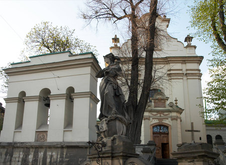 Statue and belfry near Saint Antony church in Lviv City,  Ukraine